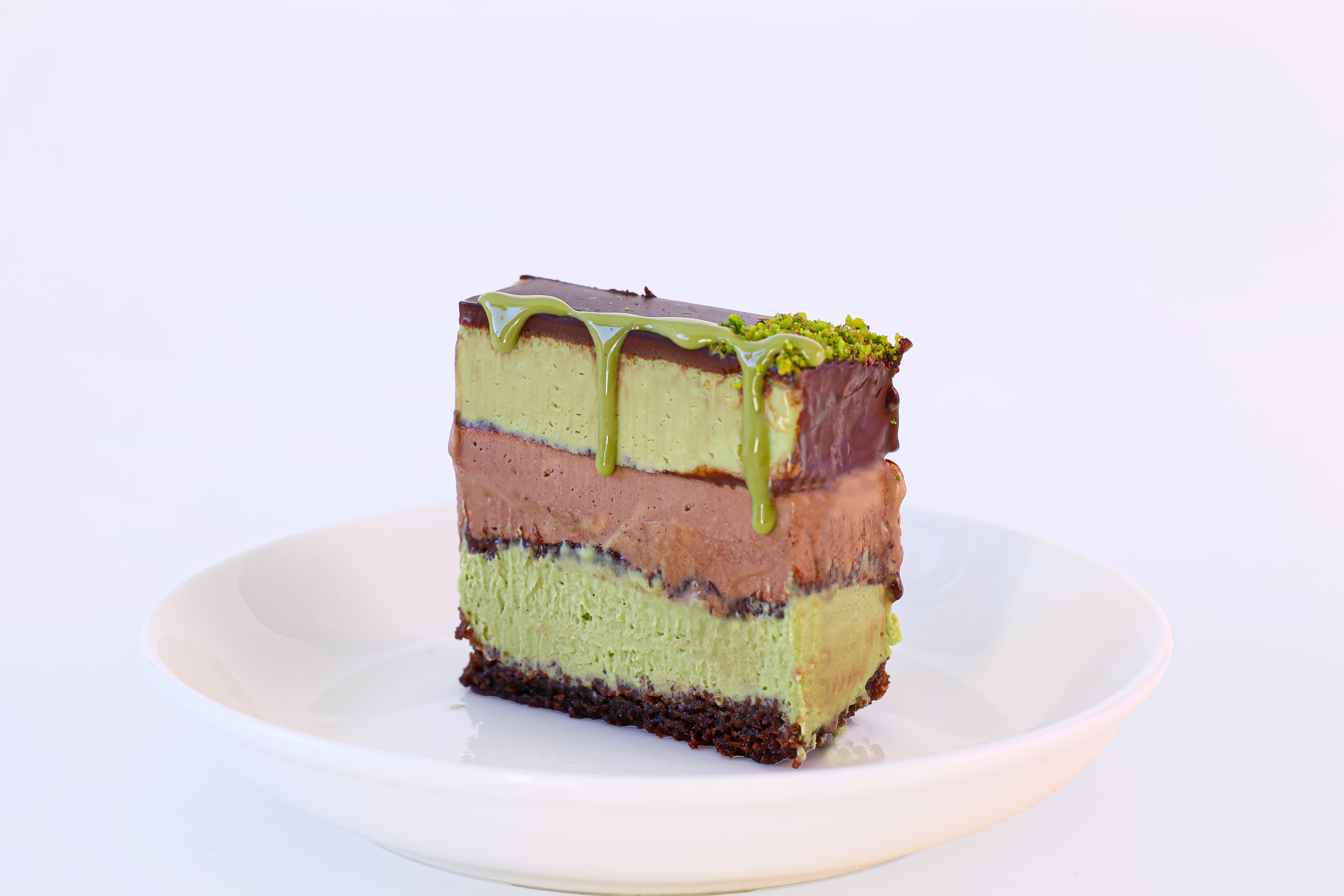 Chocolate and matcha layered dessert with green drizzle
